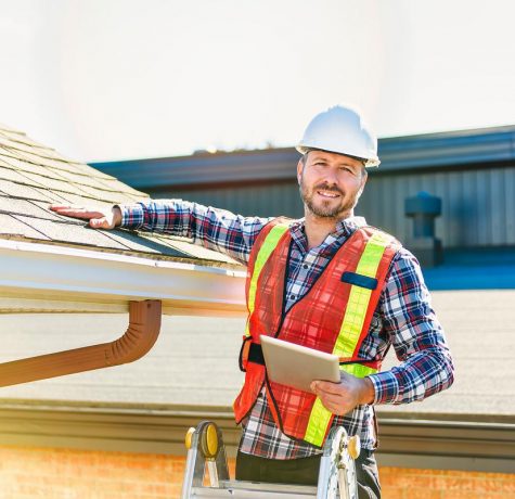 Professional roofers installing felt roofing in London, UK