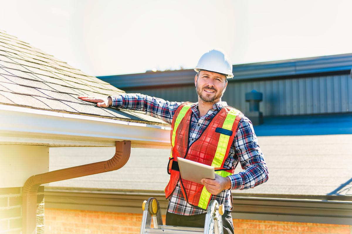Professional roofers installing felt roofing in London, UK