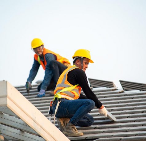 Expert workers installing an asphalt roof in London, UK